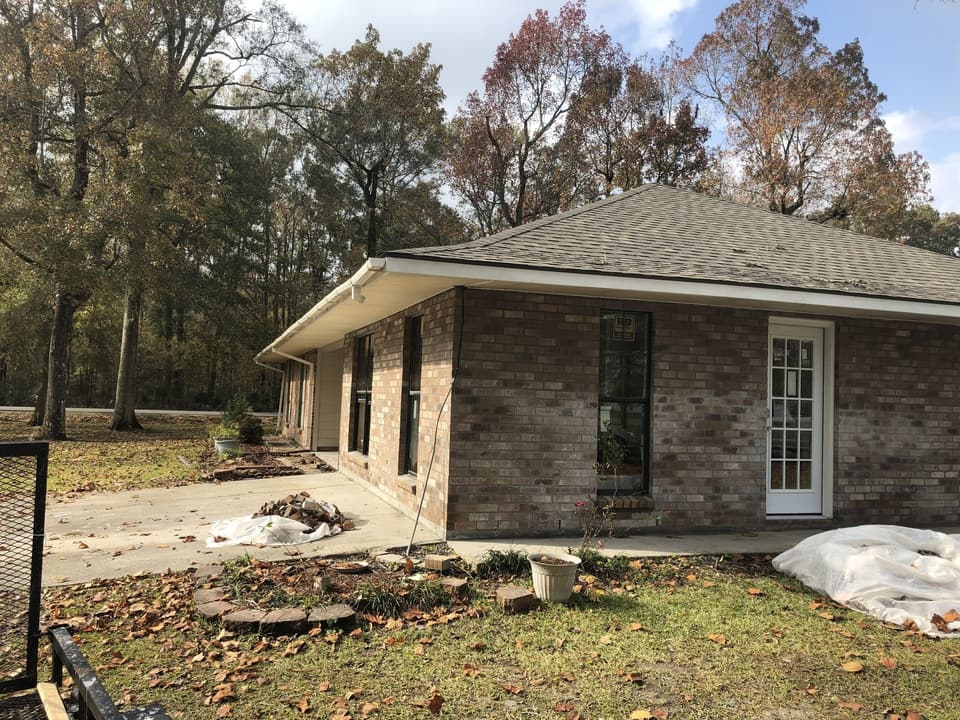 Former carport enclosed in brick, with new windows and a French door
