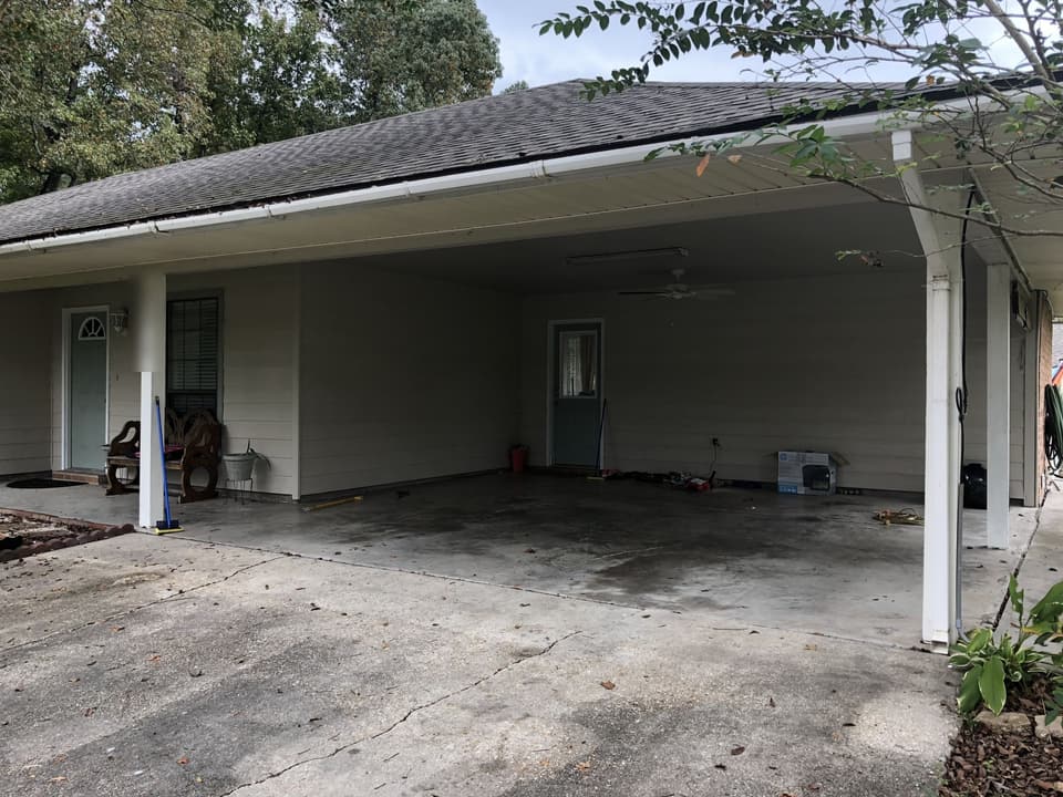 Open attached carport on a house before it was enclosed