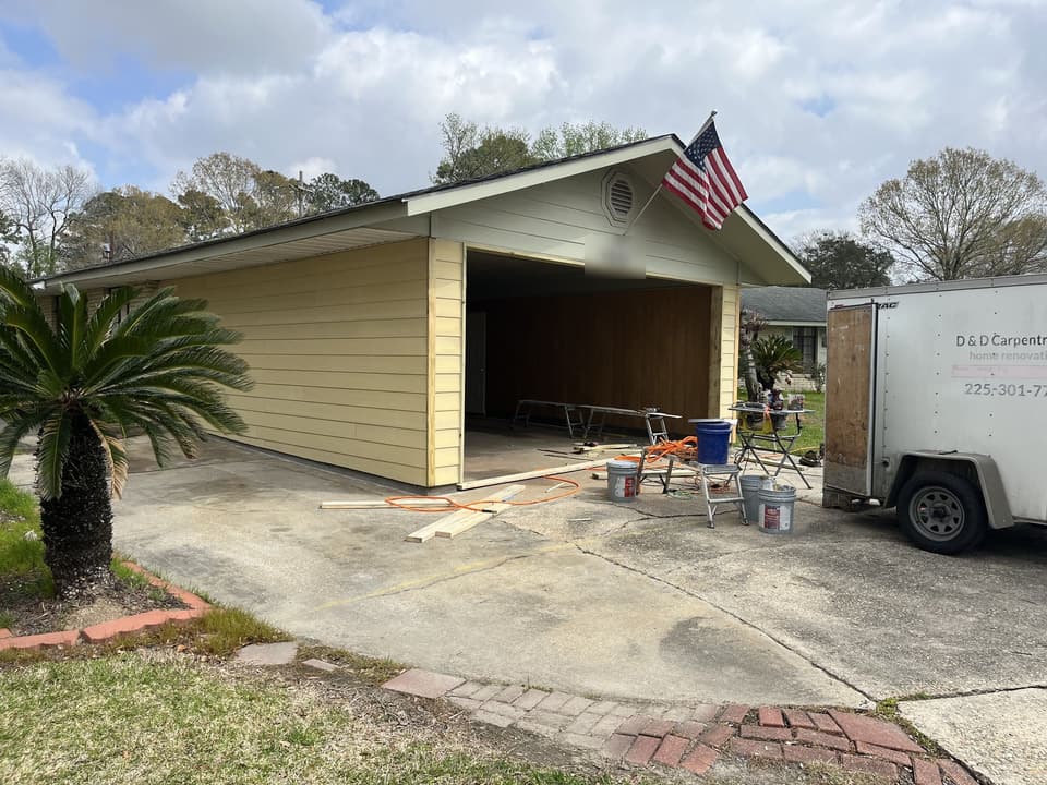 Same carport enclosed into a garage with new yellow siding and trim