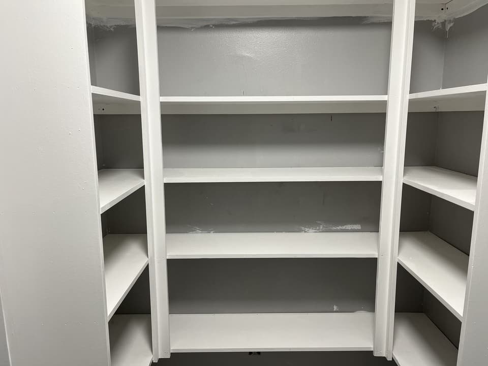 Same closet with floor-to-ceiling painted built-in shelving