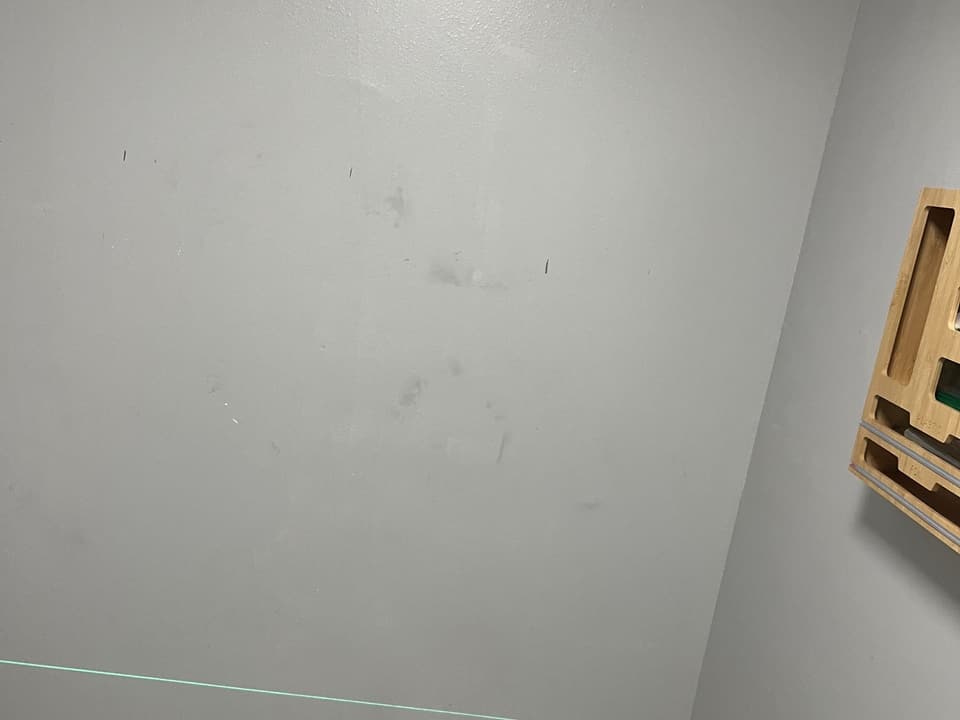 Bare closet wall before the built-in shelving
