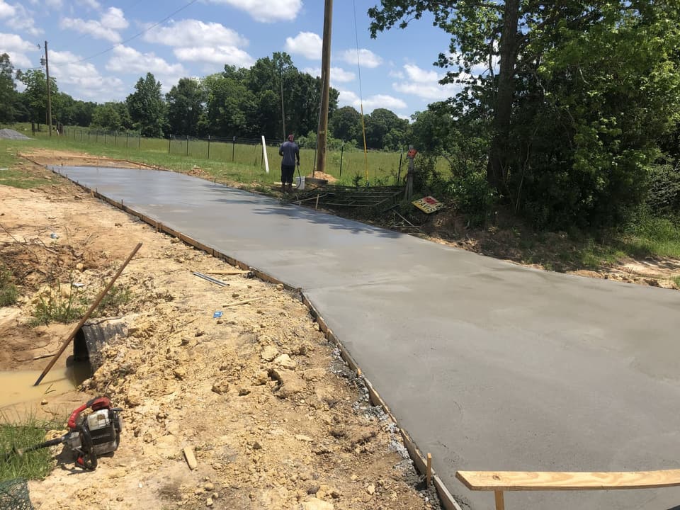 Long concrete driveway freshly poured and finished