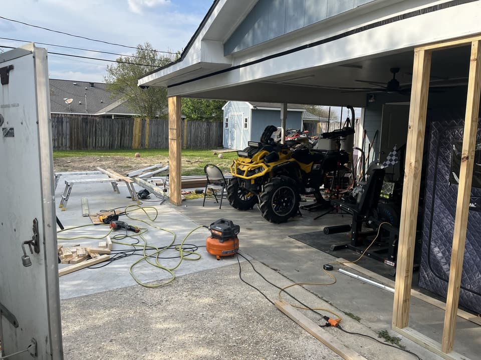 Open-sided carport garage with framing started, before the enclosure