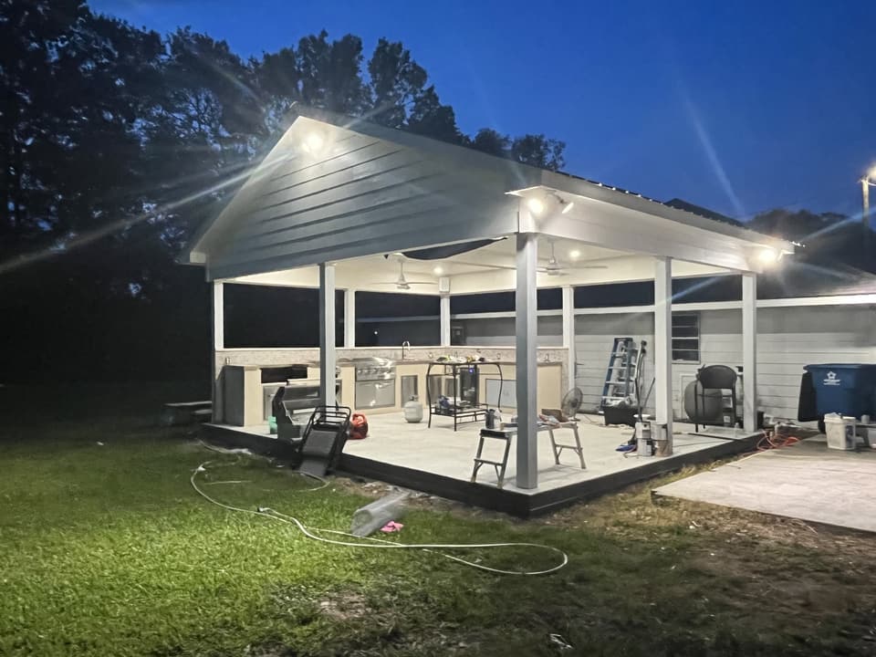 The finished pool pavilion at dusk with its ceiling lights on