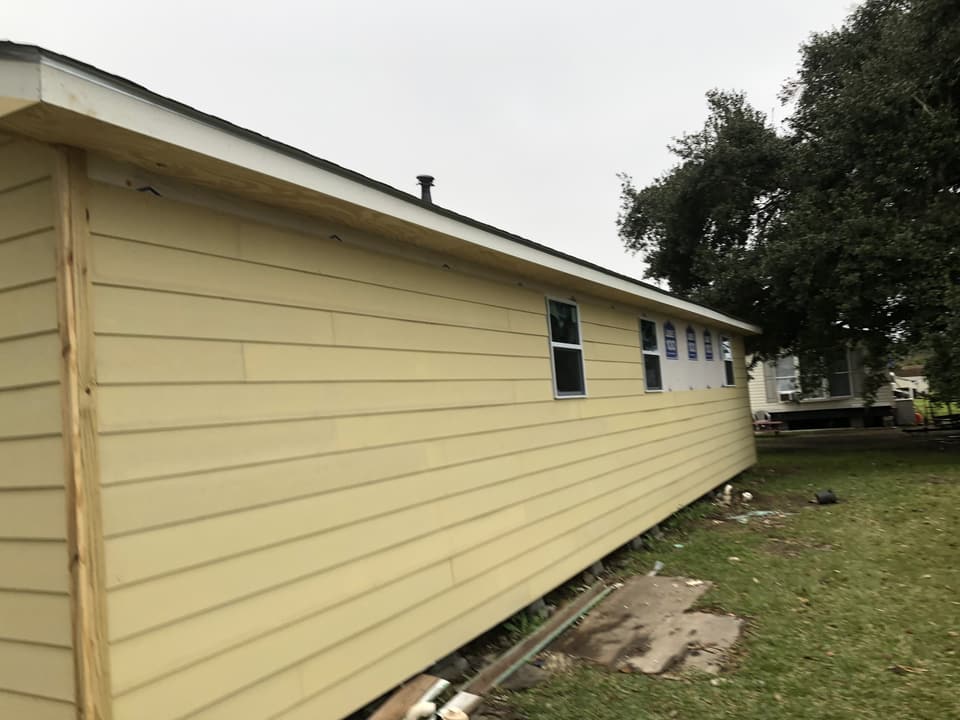 Same raised house re-sided in new yellow lap siding