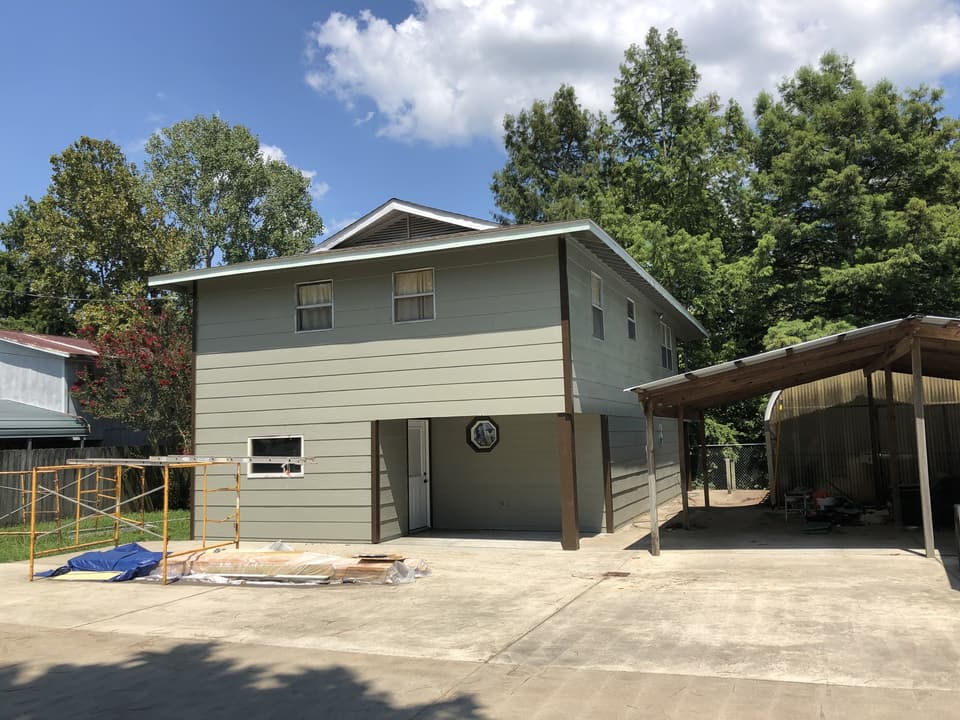Same two-story house re-sided and painted gray-green